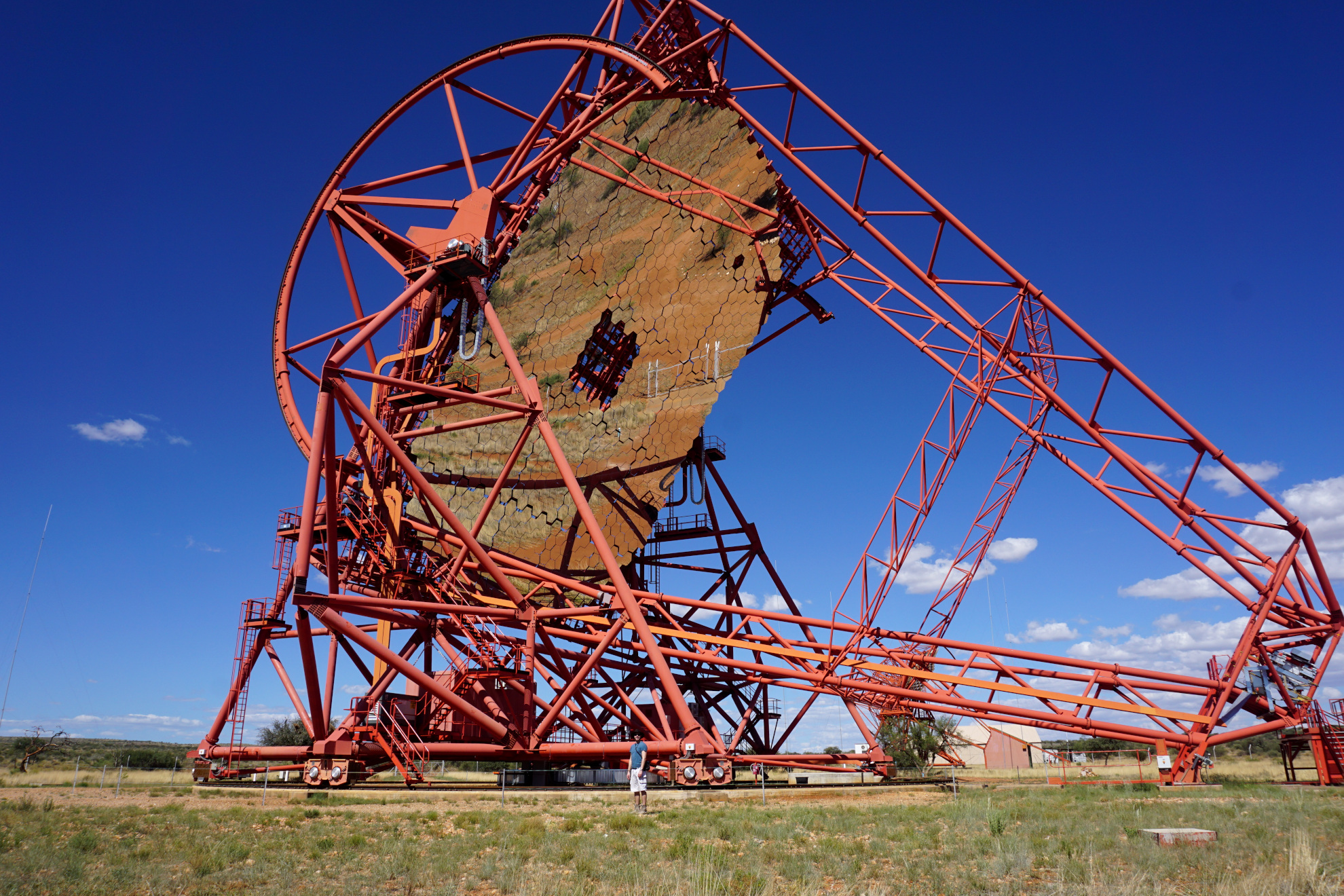 Gigantic red HESS telescope with me (tiny human) at the front of it. I’m barely visible due to the sheer size of the telescope