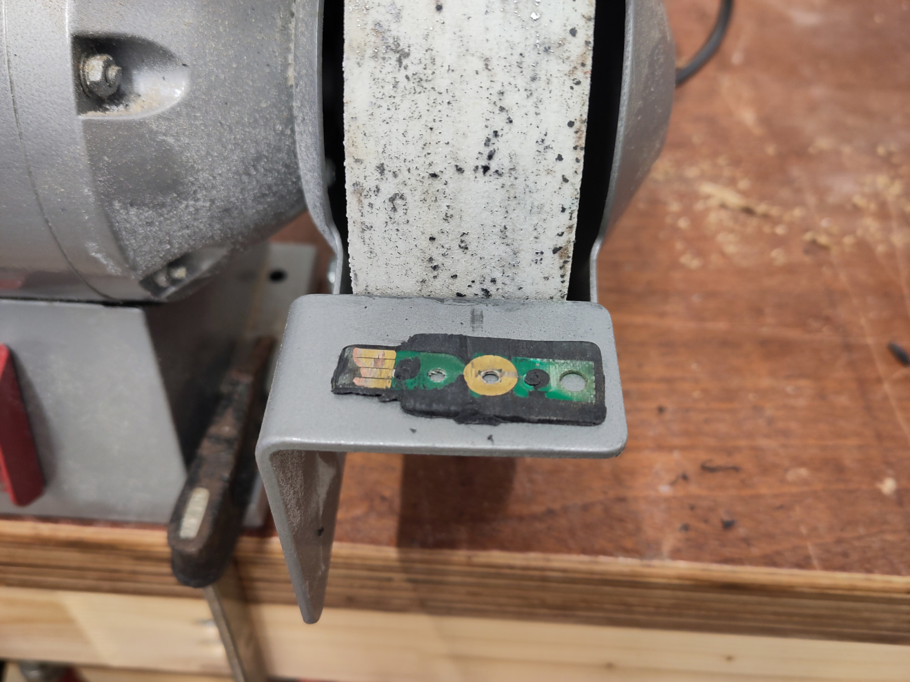 A bench grinder and a grinded Yubikey