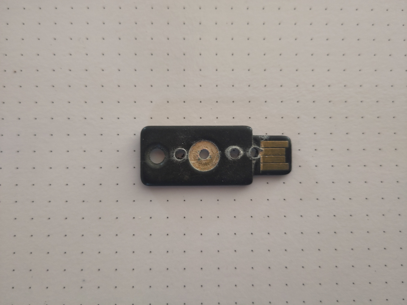 Yubikey with several drilled holes in it