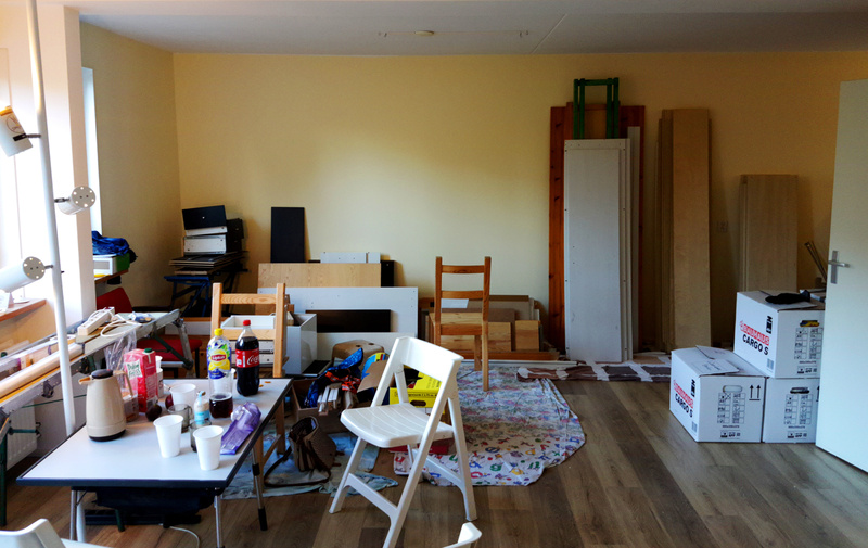 Pretty messy living room filled with moving boxes and stuff