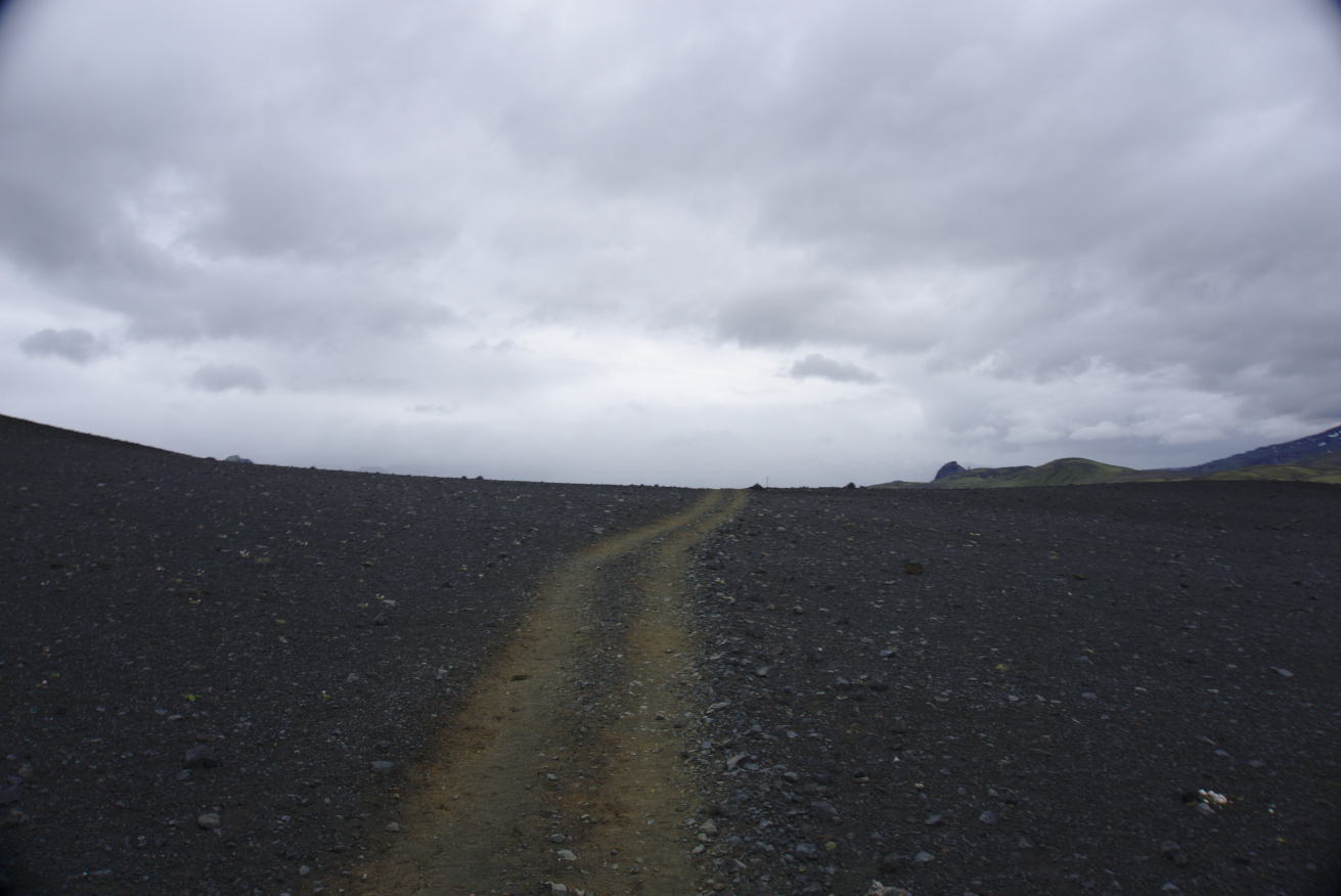 Road in the middle of a black volanic landscape